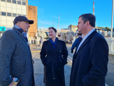 Alison Hernandez and Kevin Foster MP talking with a resident in Station Square, Paignton.