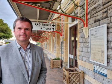 Kevin Foster MP outside Torquay Station's Ticket Office.